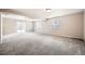 Large, carpeted basement area with several windows for natural light and a sliding door at 461 Saber Creek Dr, Monument, CO 80132