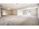 Spacious basement with neutral paint, carpet and lighting plus a door and sliding glass door at 461 Saber Creek Dr, Monument, CO 80132