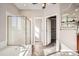 Bright bathroom featuring a glass-enclosed shower, soaking tub, and a large walk-in closet at 461 Saber Creek Dr, Monument, CO 80132