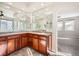 Bathroom with dual vanities, large mirrors, and a peek into the primary bedroom at 461 Saber Creek Dr, Monument, CO 80132
