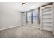 Bedroom with carpet, large built-in bookshelves, and a bright window at 461 Saber Creek Dr, Monument, CO 80132