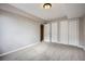 Neutral painted bedroom with carpet, a window and a closet with sliding doors at 461 Saber Creek Dr, Monument, CO 80132
