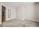 Carpeted bedroom featuring an open door and a large window at 461 Saber Creek Dr, Monument, CO 80132