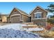 Charming two-story home with stone accents, a three-car garage, and landscaped front yard at 461 Saber Creek Dr, Monument, CO 80132