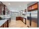 Spacious kitchen with wood cabinets, stainless steel appliances, and an open view into the living space at 461 Saber Creek Dr, Monument, CO 80132