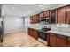 Modern kitchen featuring wood cabinets, stainless steel appliances, and a bright breakfast nook at 461 Saber Creek Dr, Monument, CO 80132