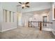 Open-concept living room with neutral carpeting and a view of the stairway at 461 Saber Creek Dr, Monument, CO 80132