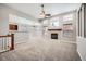 Spacious living room with a fireplace, large windows, and neutral carpeting at 461 Saber Creek Dr, Monument, CO 80132