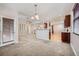 Open living room with a view to the kitchen, dining, and stairway at 461 Saber Creek Dr, Monument, CO 80132