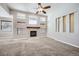 Bright living room featuring a fireplace, many windows, and neutral carpeting at 461 Saber Creek Dr, Monument, CO 80132