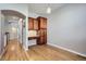 A home office with built-in wood desk, shelving, and a bright overhead light at 461 Saber Creek Dr, Monument, CO 80132