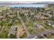 Panoramic aerial shot displays houses near a scenic lake, surrounded by abundant trees and mountains in the background at 4901 Redwood Dr, Littleton, CO 80123