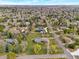 Wide aerial perspective of a neighborhood featuring well-landscaped yards, mature trees, and lush green spaces on a bright day at 4901 Redwood Dr, Littleton, CO 80123