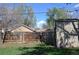 Fenced backyard showcasing a well-kept lawn, shed, and views of the home's exterior at 1750 Jamaica St, Aurora, CO 80010