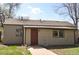 Charming single-story home featuring a red front door and well-maintained lawn at 1750 Jamaica St, Aurora, CO 80010