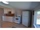 Functional kitchen layout with white appliances, ample counter space, and tile flooring for easy maintenance at 1750 Jamaica St, Aurora, CO 80010