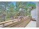 Wood balcony overlooking lush green trees providing a private outdoor space at 23566 Pondview Pl # F, Golden, CO 80401