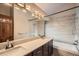 Modern bathroom with a double sink vanity and tiled shower and tub at 23566 Pondview Pl # F, Golden, CO 80401