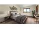 Serene bedroom showcases a comfortable bed with stylish lamps and a tranquil view through the window at 23566 Pondview Pl # F, Golden, CO 80401