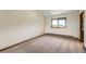 Cozy bedroom with neutral carpet and a view through the window at 23566 Pondview Pl # F, Golden, CO 80401