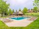 Inviting community pool with ample lounge chairs, clubhouse and lush landscaping, creating a resort-like atmosphere at 23566 Pondview Pl # F, Golden, CO 80401