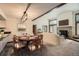 Charming dining area with vaulted ceiling, wood beam, and adjacent fireplace and living room at 23566 Pondview Pl # F, Golden, CO 80401