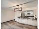 Modern kitchen with stainless steel appliances and a sleek breakfast bar under a stylish light fixture at 23566 Pondview Pl # F, Golden, CO 80401