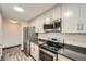 Bright kitchen featuring stainless steel appliances, ample cabinet space, and modern finishes throughout at 23566 Pondview Pl # F, Golden, CO 80401