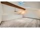 Spacious living area with vaulted ceiling, wooden beam, and two skylights for natural light at 23566 Pondview Pl # F, Golden, CO 80401