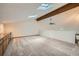 Open living space with neutral carpet, white walls, and ample natural light from skylights at 23566 Pondview Pl # F, Golden, CO 80401