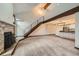 Open living room with a stone fireplace, vaulted ceiling, and modern staircase at 23566 Pondview Pl # F, Golden, CO 80401