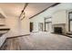 Inviting living room with vaulted ceiling, fireplace, and seamless flow to the dining and kitchen areas at 23566 Pondview Pl # F, Golden, CO 80401