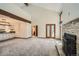 Expansive living room with fireplace, kitchen and adjoining rooms at 23566 Pondview Pl # F, Golden, CO 80401