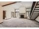 Bright living room features a cozy fireplace, vaulted ceilings, and access to a balcony at 23566 Pondview Pl # F, Golden, CO 80401