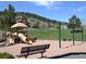 Community playground with slides and swings, set against a backdrop of scenic hills and residential homes at 23566 Pondview Pl # F, Golden, CO 80401