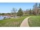 Scenic view of the pond and gazebo, walking path, and lush green surroundings, inviting outdoor recreation and relaxation at 23566 Pondview Pl # F, Golden, CO 80401