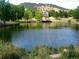 Scenic community pond with a gazebo, reflecting the blue sky, and providing a peaceful outdoor retreat at 23566 Pondview Pl # F, Golden, CO 80401