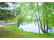 Picturesque pond surrounded by trees with lush foliage, offering a serene and tranquil environment at 23566 Pondview Pl # F, Golden, CO 80401