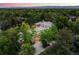 Aerial view of a luxurious home surrounded by lush greenery and mature trees on a sprawling lot at 850 E Radcliff Ave, Cherry Hills Village, CO 80113