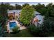 Stunning estate with mature trees, a swimming pool, an outdoor seating area, and meticulously manicured lawn at 850 E Radcliff Ave, Cherry Hills Village, CO 80113