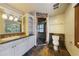 Well-appointed bathroom with a glass-enclosed shower, vanity, and neutral tile flooring at 850 E Radcliff Ave, Cherry Hills Village, CO 80113