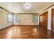 Bedroom features hardwood floors, large windows, baseboard heating and closet with wooden doors at 850 E Radcliff Ave, Cherry Hills Village, CO 80113