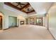 Spacious carpeted bedroom featuring a tray ceiling with fans, french doors to the exterior, and a stone fireplace at 850 E Radcliff Ave, Cherry Hills Village, CO 80113