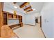 Spacious bonus room with beamed ceilings, built-in shelving, and cozy ambiance at 850 E Radcliff Ave, Cherry Hills Village, CO 80113