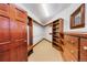Walk-in closet with custom wood shelving and drawers provides ample storage space and organization at 850 E Radcliff Ave, Cherry Hills Village, CO 80113