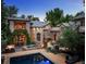 Beautiful stone and brick home with outdoor fire pit, pool, and lush landscaping at 850 E Radcliff Ave, Cherry Hills Village, CO 80113