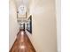 Long hallway with hardwood floors, neutral walls, and attractive light fixture at 850 E Radcliff Ave, Cherry Hills Village, CO 80113