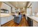 Spacious kitchen with hardwood floors, stainless steel appliances, white cabinets, and stone accents at 850 E Radcliff Ave, Cherry Hills Village, CO 80113