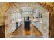 Gourmet kitchen features custom cabinets, stone archway, hardwood floors and stainless steel appliances at 850 E Radcliff Ave, Cherry Hills Village, CO 80113