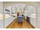 Gourmet kitchen with custom cabinets, hardwood floors, stainless steel appliances, and center island at 850 E Radcliff Ave, Cherry Hills Village, CO 80113